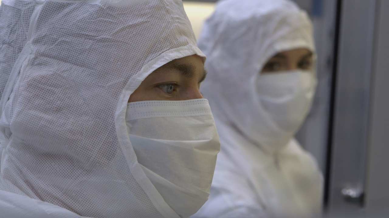 two people with white masks on
